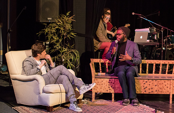 Picture of men on stage talking into microphones