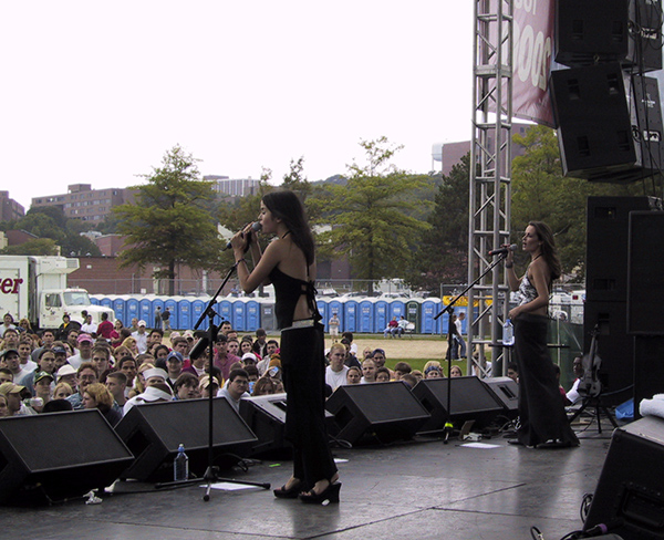 Picture of two women performing on stage at outdoor festival