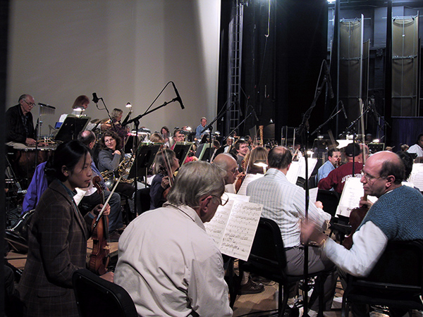 Orchestra musicians sitting together holding instruments