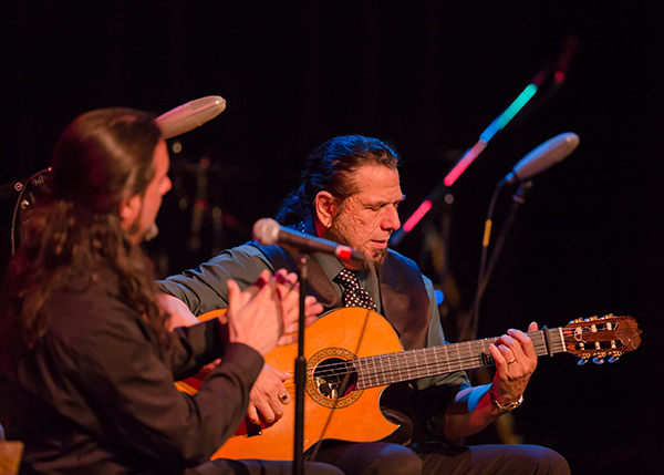 Man playing acoustic guitar on stage