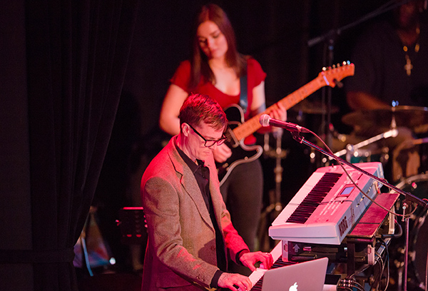 Man playing keyboard and woman playing electric guitar